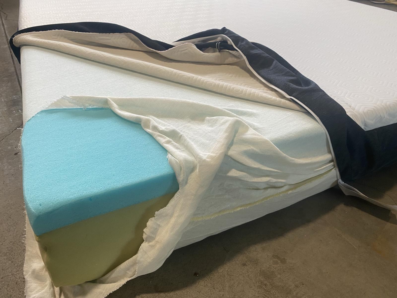 Memory foam mattress layers showing dense closed-cell structure that traps moisture